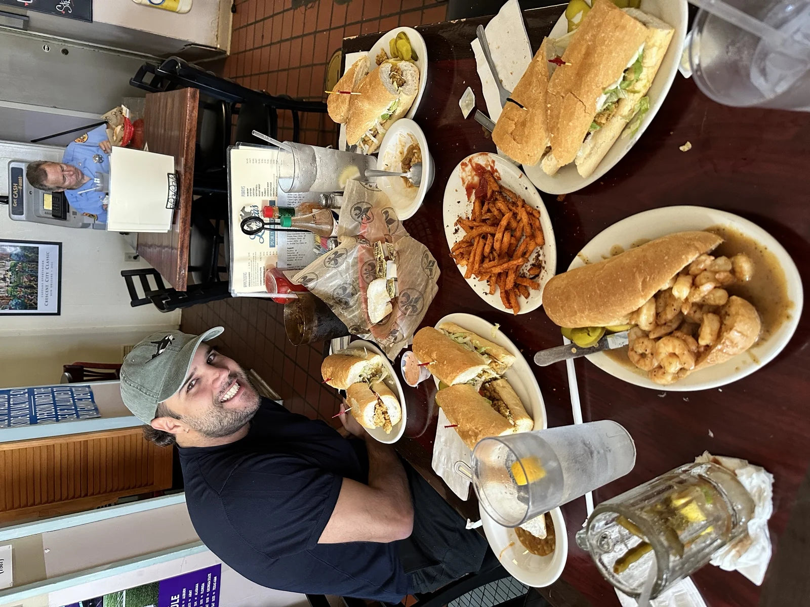 po'boy shop table spread: fried shrimp po'boy, roast beef po'boys, sweet potato fries, …