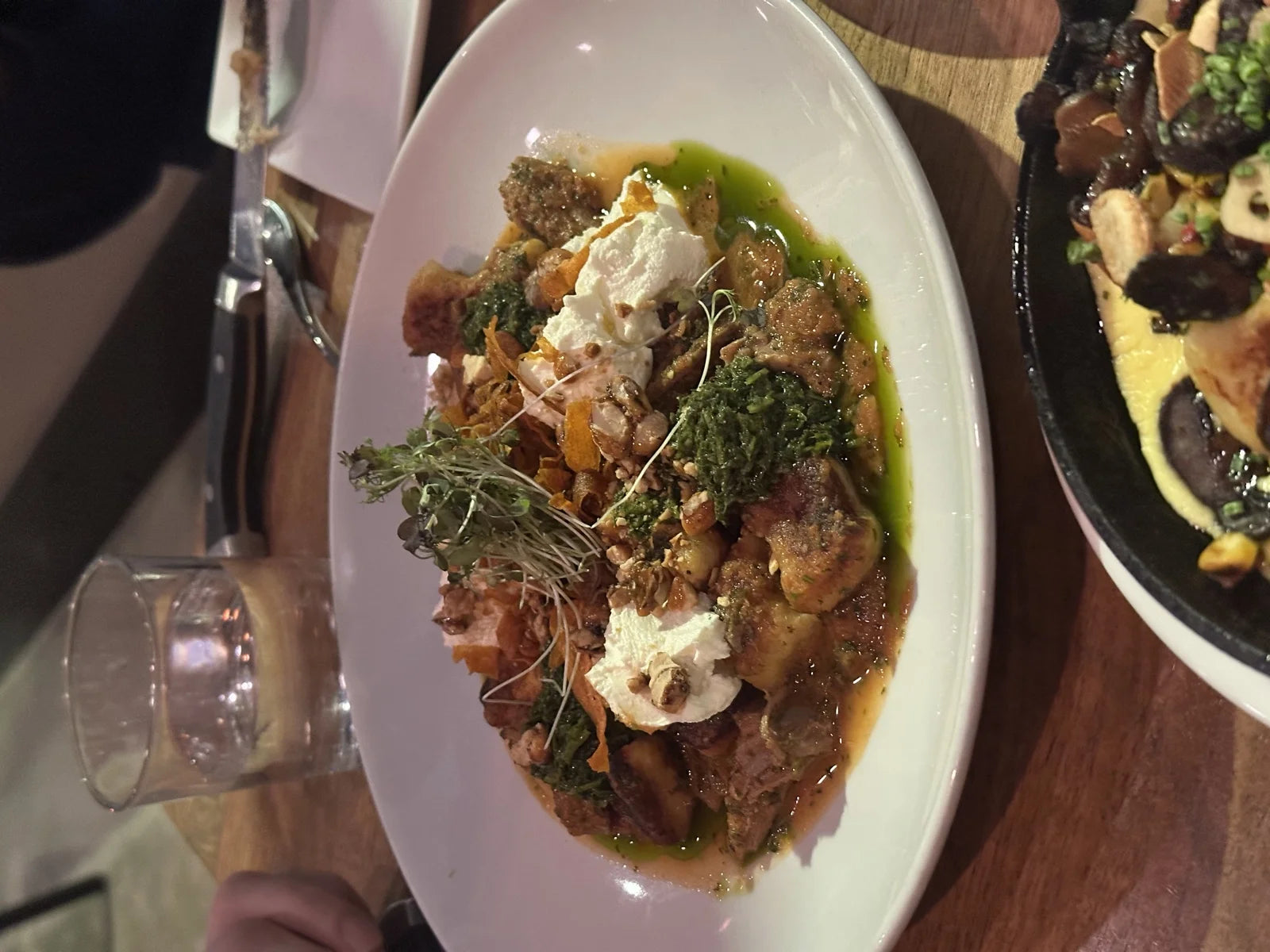 plated gnocchi w/ burrata dollops + chimichurri drizzle + pistachios + microgreens; ski…