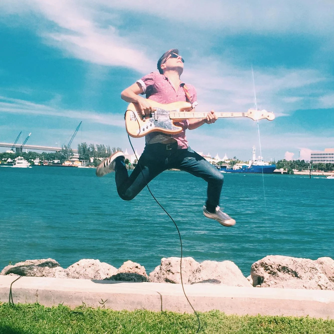 Robby Hunter mid-jump with bass, Port of Miami