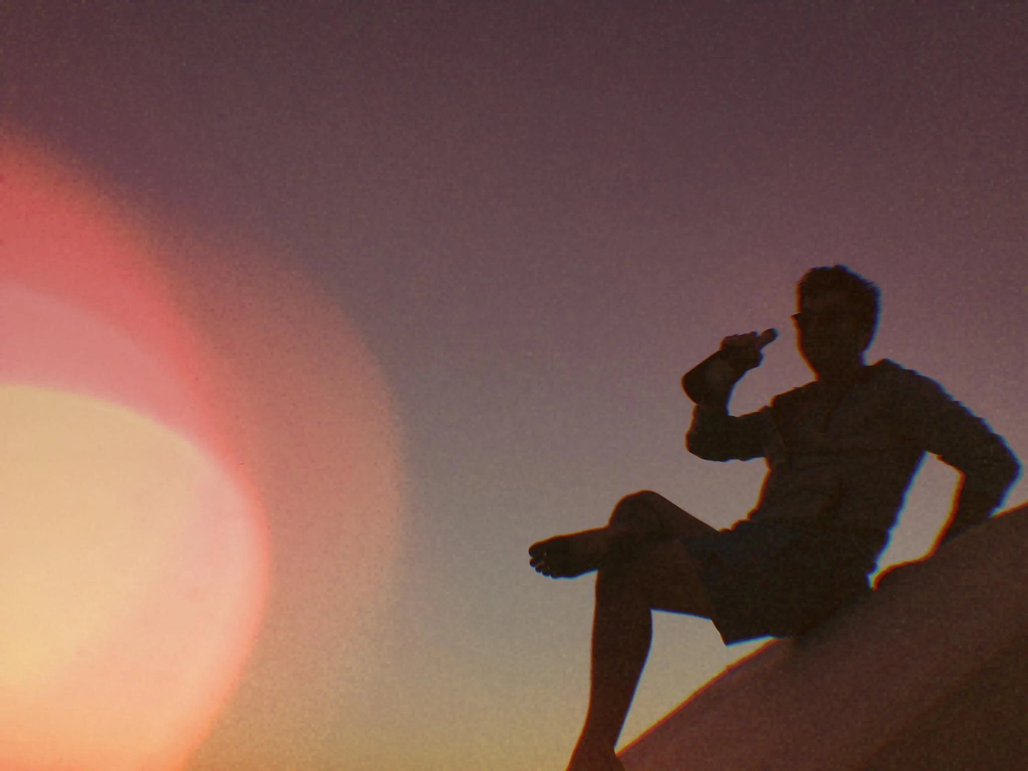 Sunset flare, silhouette, drink up.